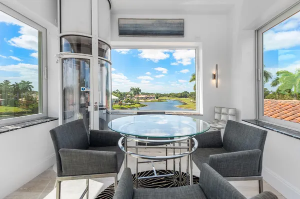 an aerial view of a house with a garden and lake view