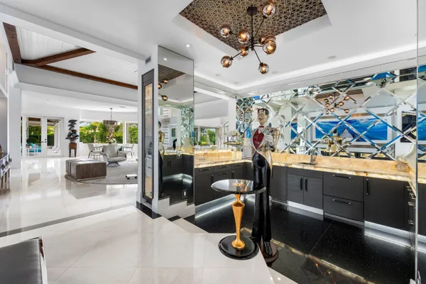 a kitchen with stainless steel appliances granite countertop a sink a stove and a wooden floors