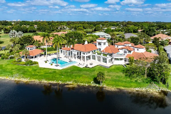 a living room with furniture a fireplace and a large window
