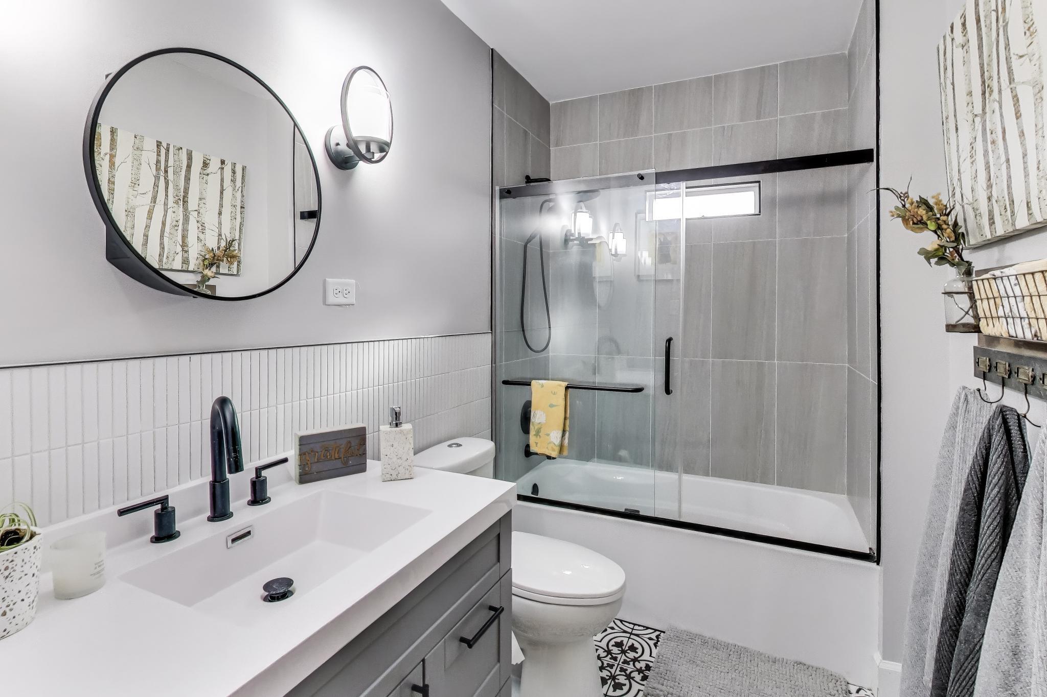 453 Chestnut Street Valparaiso, IN 46385 - Photo 22 of 47 a bathroom with a sink a mirror a toilet and a shower