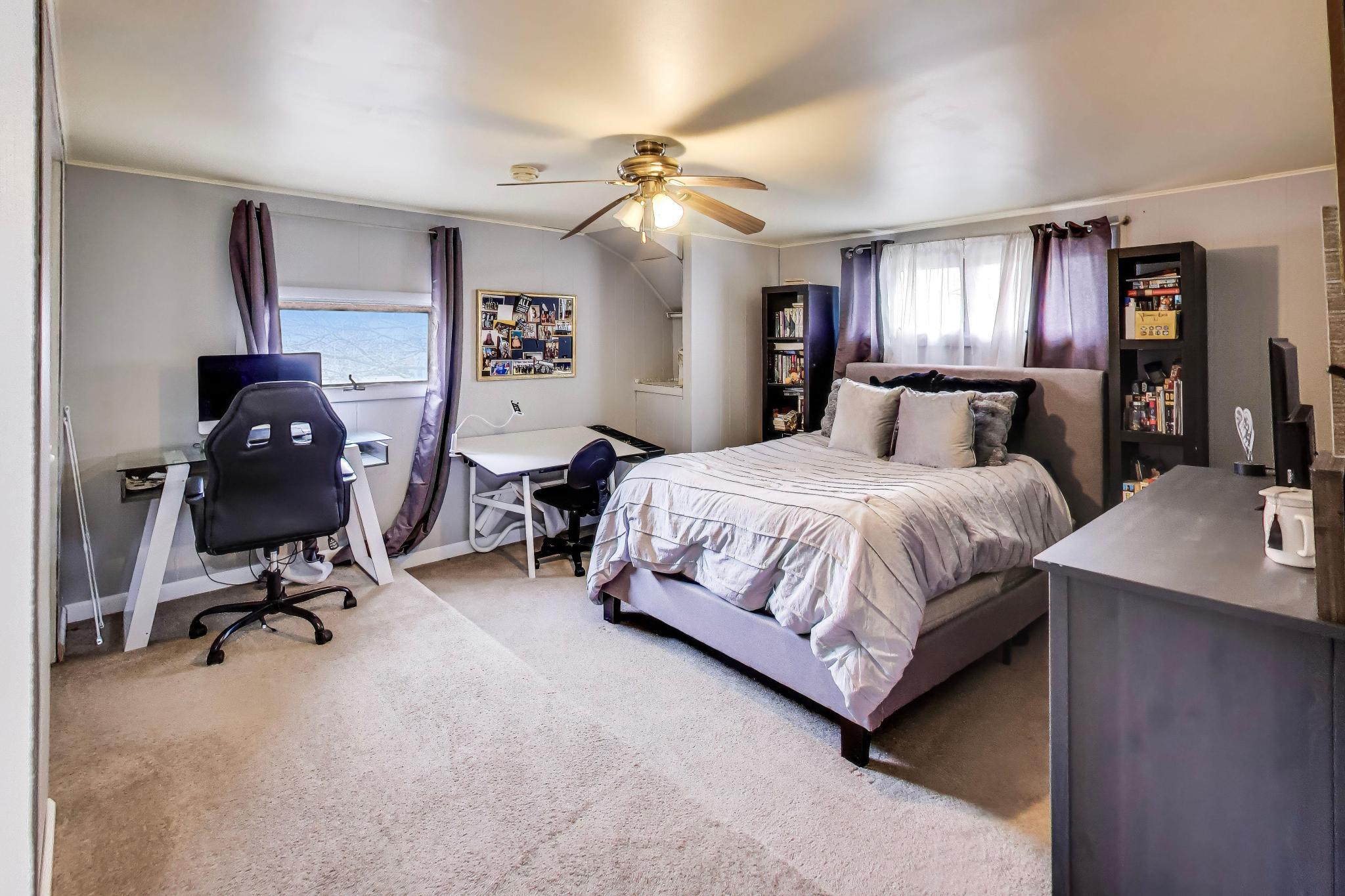 453 Chestnut Street Valparaiso, IN 46385 - Photo 30 of 47 a bedroom with a bed gym equipment and a chandelier