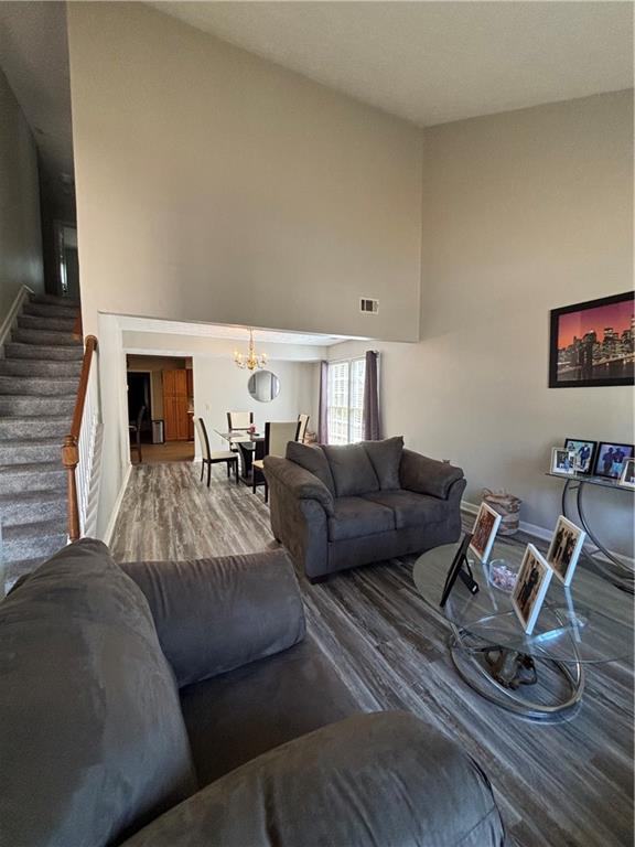 4949 Penscot Way Stone Mountain, GA 30088 - Photo 4 of 40 a living room with furniture a fireplace and gym equipment