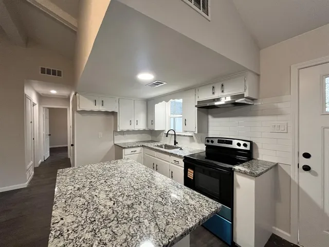 a kitchen with a stove and a refrigerator