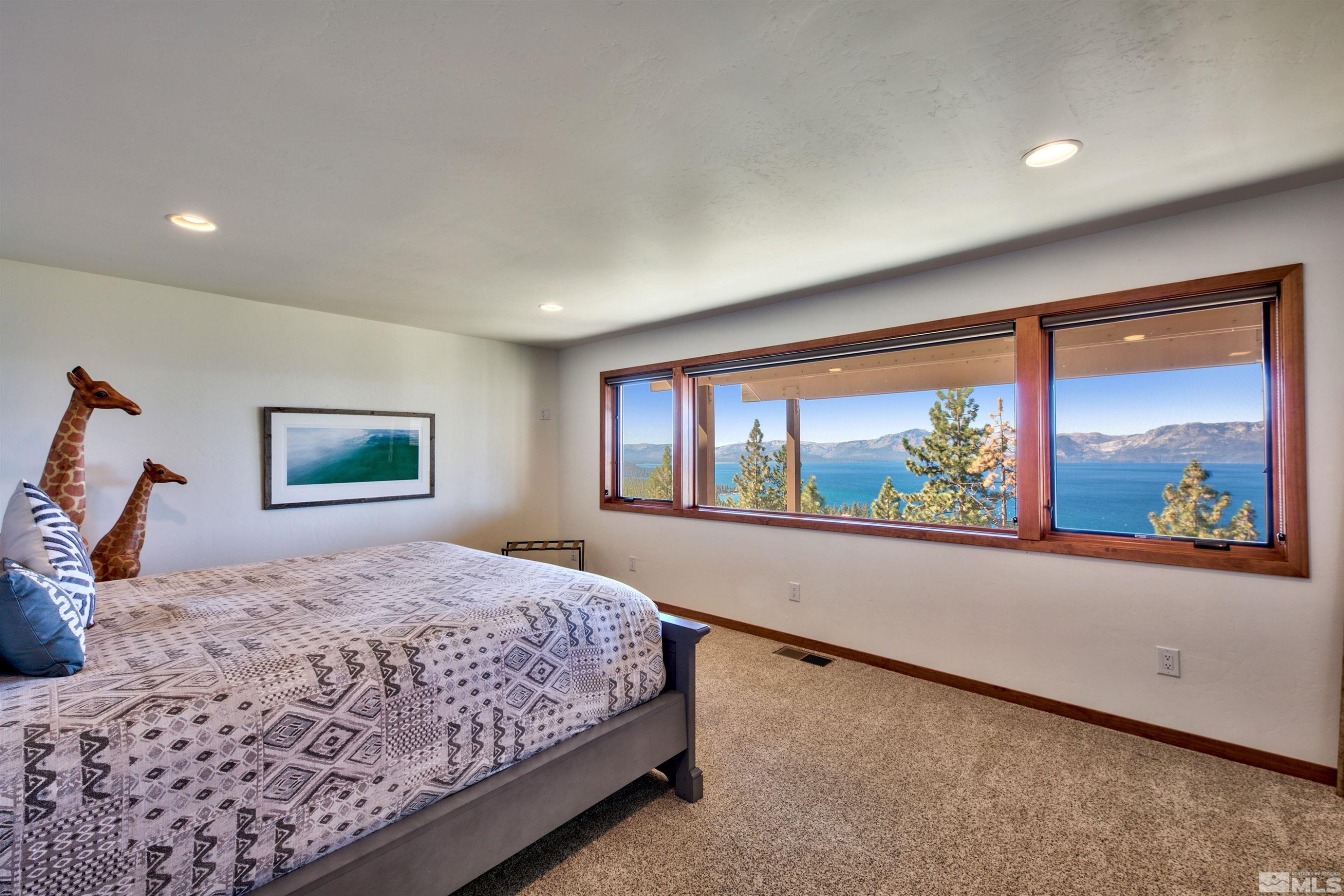 319 Pheasant Drive Glenbrook, NV 89413 - Photo 29 of 40 a bedroom with a large bed and a window