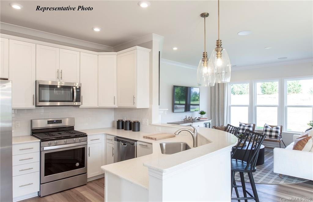 813 Canoe Song Road, Unit 371 Fort Mill, SC 29708 - Photo 5 of 23 a kitchen that has a lot of cabinets and wooden floor