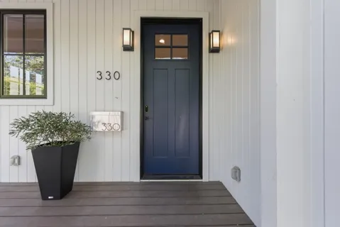 a view of a hallway with wooden floor and chair