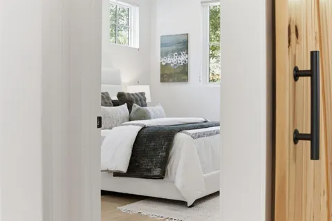 a bedroom with a bed and a window