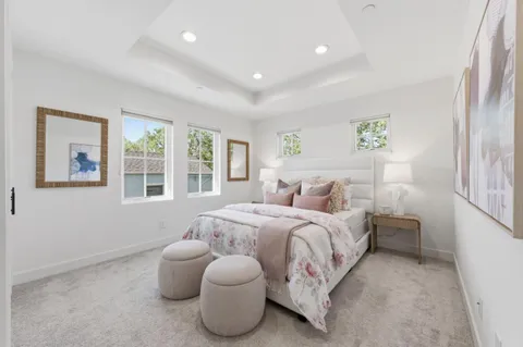 a spacious bedroom with a bed and a large window