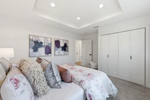 a bedroom with a large bed and a walk in closet