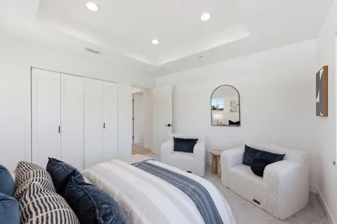 a bedroom with a bed and a potted plant