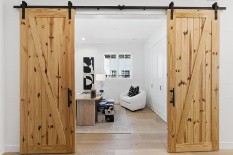a view of a hallway with wooden floor and closet