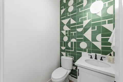 a bathroom with a toilet a sink and a mirror