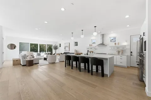 a open kitchen with stainless steel appliances kitchen island granite countertop a sink and cabinets