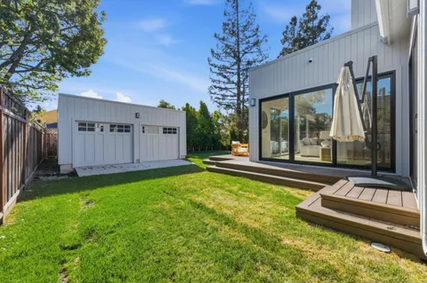 a view of a house with backyard and porch area