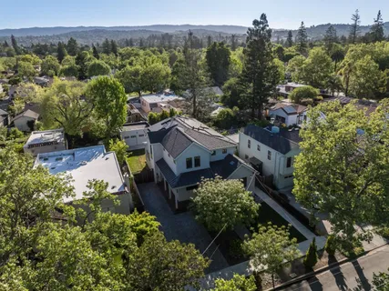 an aerial view of a house with a yard
