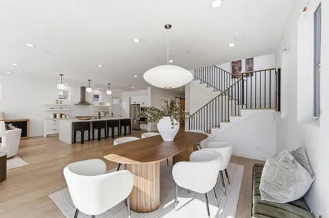 a dining room with furniture and a chandelier