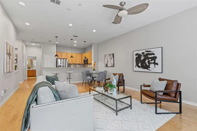 a living room with furniture and a ceiling fan