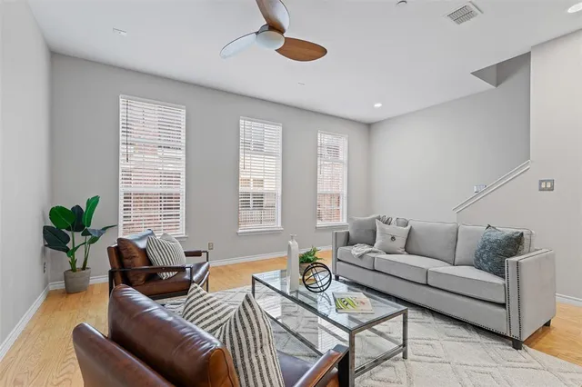 a living room with furniture and a potted plant