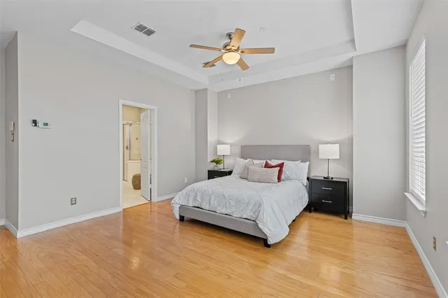 a bedroom with a bed and a ceiling fan