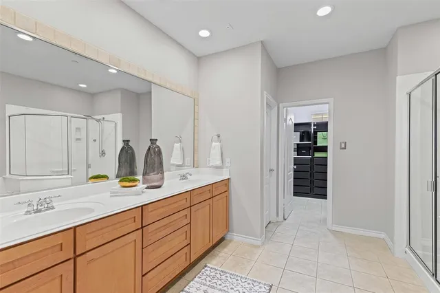 a spacious bathroom with a granite countertop sink and a mirror