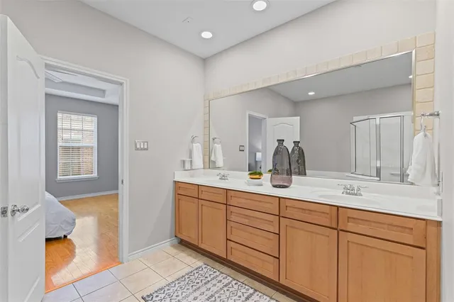 a bathroom with a double vanity sink and a mirror