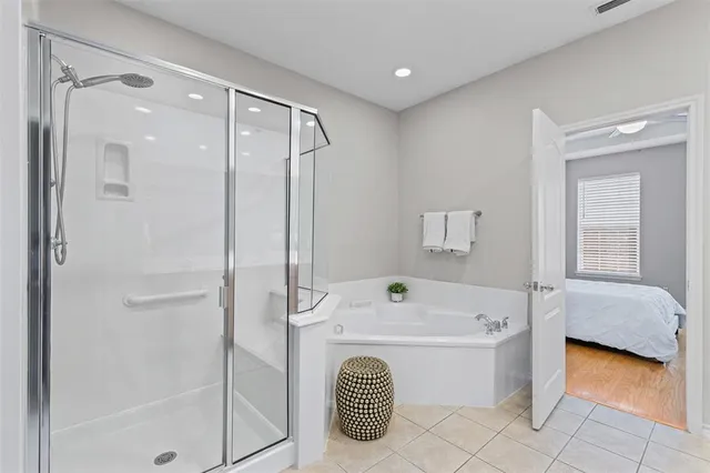 a bathroom with a tub a sink and a shower