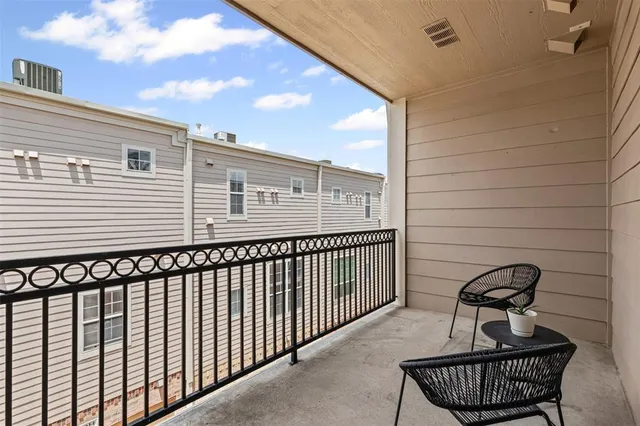 a view of a balcony with furniture