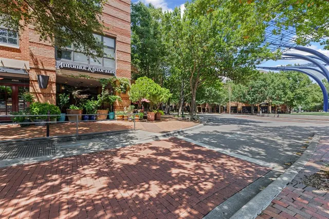 a view of a garden with a building in the background