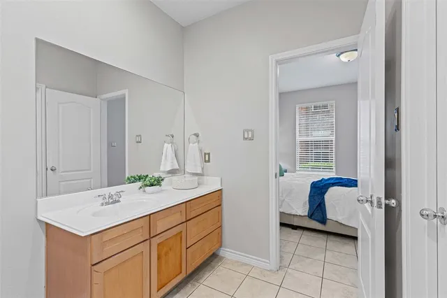 a bathroom with a sink vanity and mirror