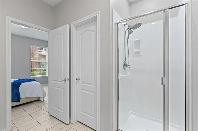 a bathroom with a shower and a sink