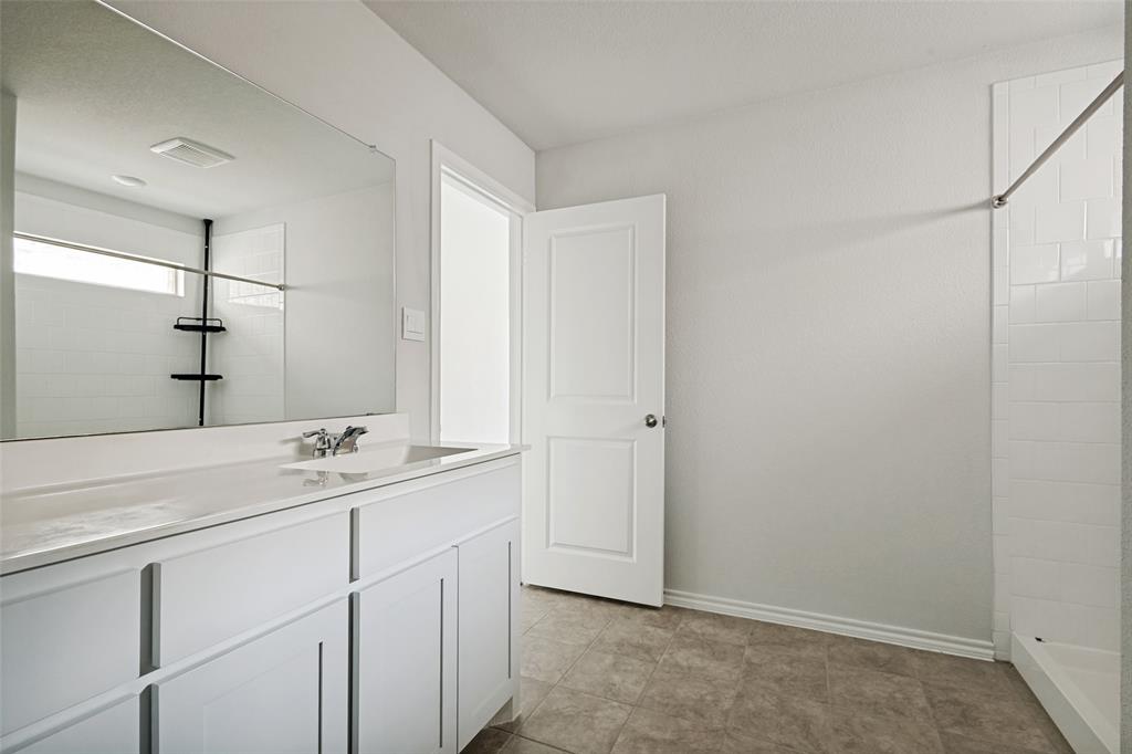 621 Spaulding Street Justin, TX 76247 - Photo 18 of 22 a bathroom with a double vanity sink and mirror