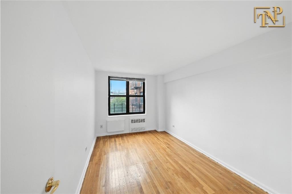 1190 East 53rd Street, Unit 5B Brooklyn, NY 11234 - Photo 11 of 15 a view of empty room with wooden floor and fan