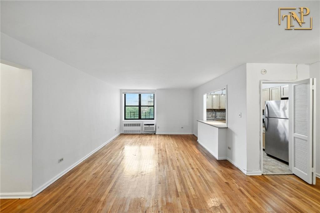 1190 East 53rd Street, Unit 5B Brooklyn, NY 11234 - Photo 3 of 15 a view of a big room with wooden floor and a kitchen