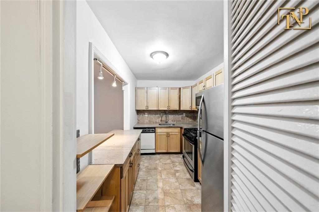 1190 East 53rd Street, Unit 5B Brooklyn, NY 11234 - Photo 7 of 15 a kitchen with a sink and a stove top oven