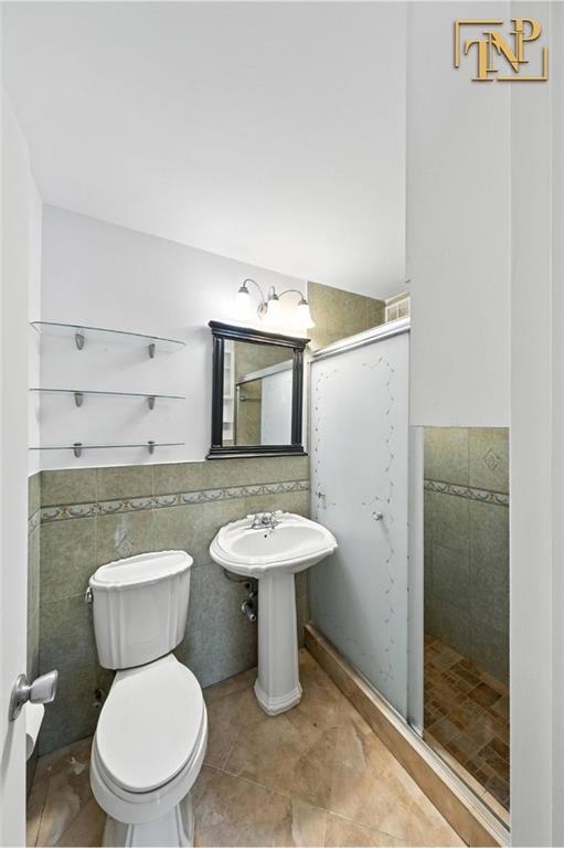1190 East 53rd Street, Unit 5B Brooklyn, NY 11234 - Photo 8 of 15 a bathroom with a toilet a sink and a shower