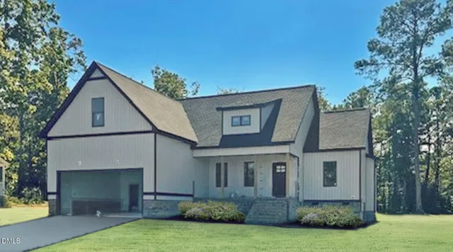 a view of a white house next to a yard with plants and trees