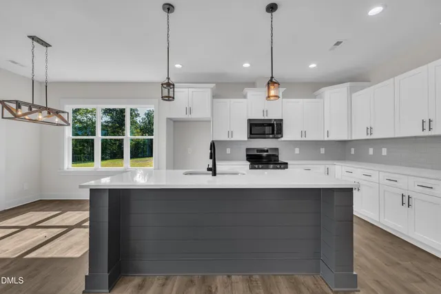 a view of a field with trees in the background
