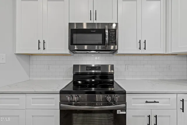 a kitchen with appliances cabinets and a window