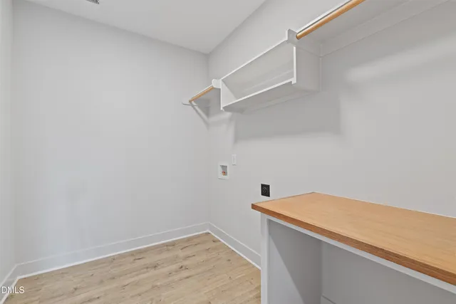 a view of walk in closet with empty racks