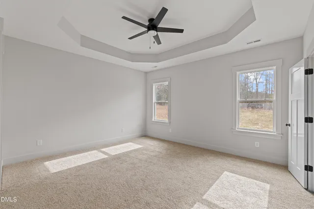 a view of a hallway with wooden floor and closet area