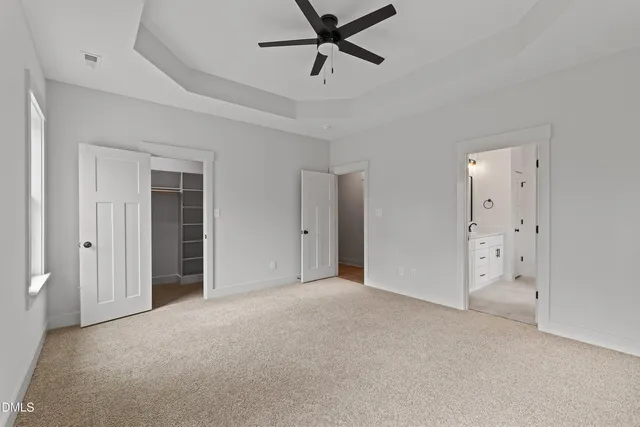 a view of a livingroom with a ceiling fan and window