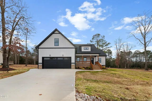 a view of a house with snow on the side of the road