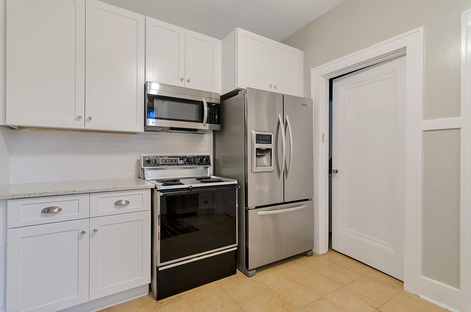 115 Cherokee Road Nashville, TN 37205 - Photo 13 of 36 a kitchen with stainless steel appliances white cabinets and a refrigerator