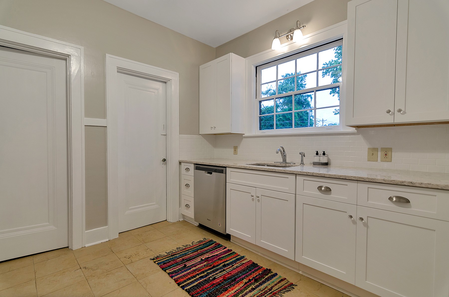 115 Cherokee Road Nashville, TN 37205 - Photo 16 of 36 a kitchen with granite countertop white cabinets and window