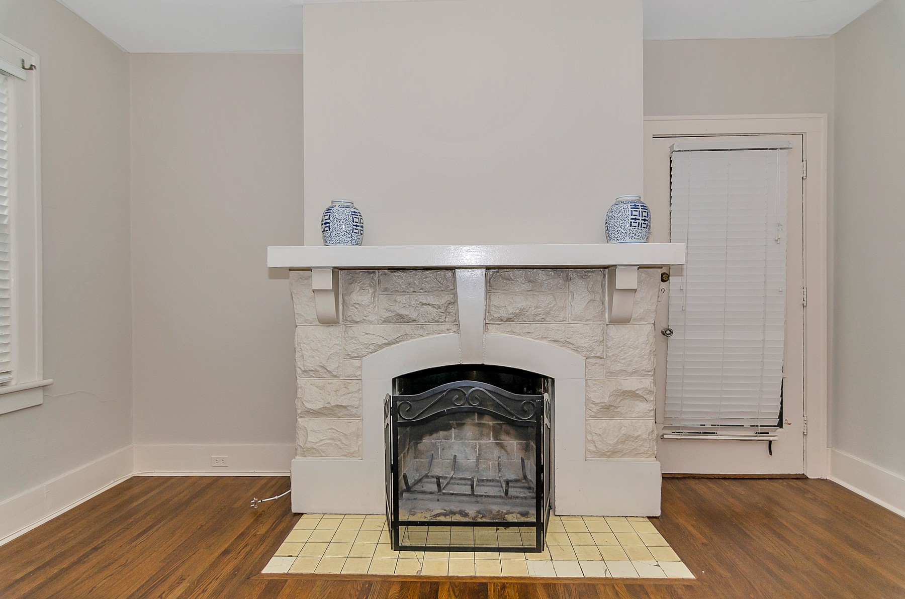 115 Cherokee Road Nashville, TN 37205 - Photo 23 of 36 a living room with a fireplace and wooden floor