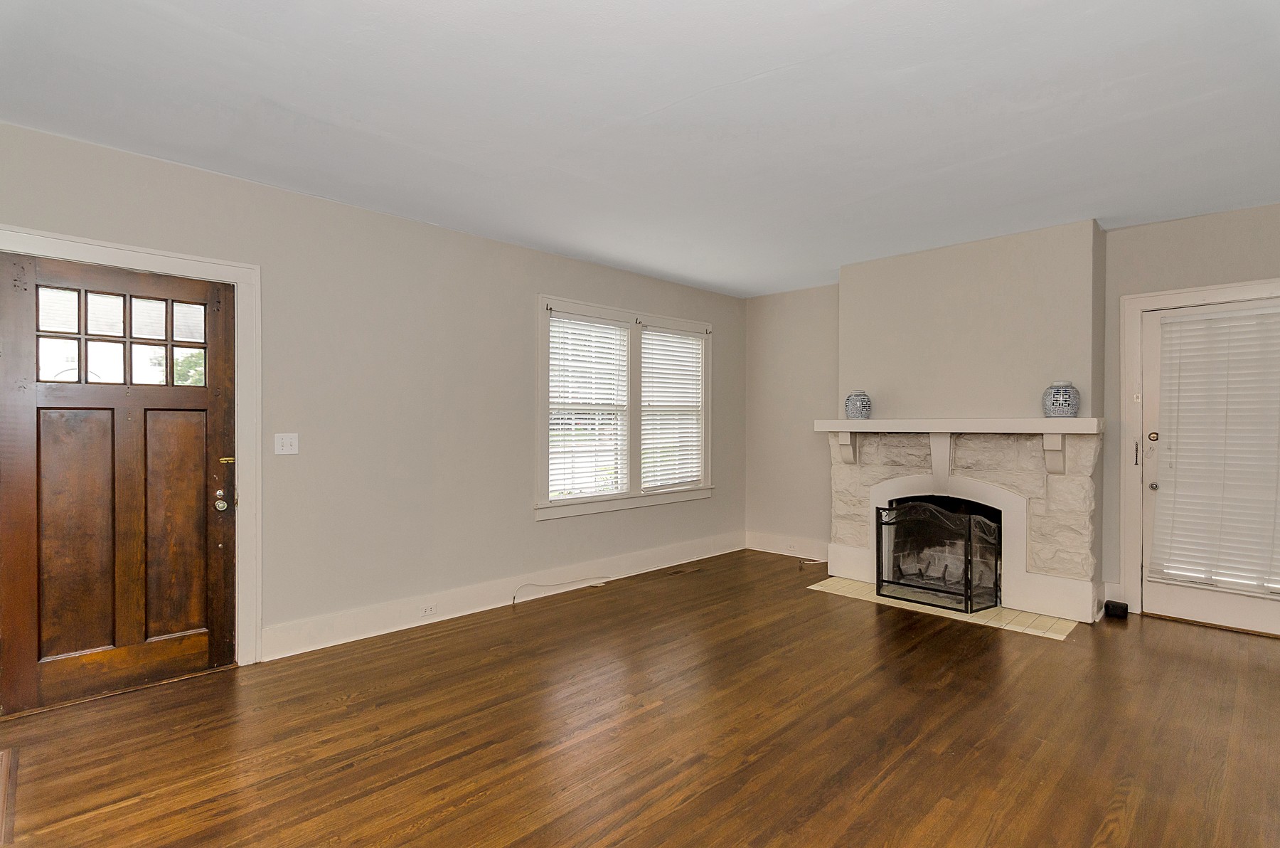 115 Cherokee Road Nashville, TN 37205 - Photo 8 of 36 an empty room with wooden floor fireplace and windows
