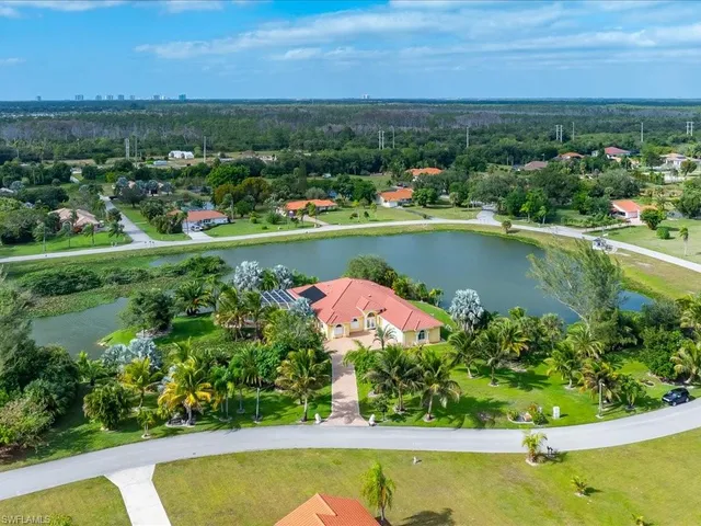 an aerial view of a house with a lake view