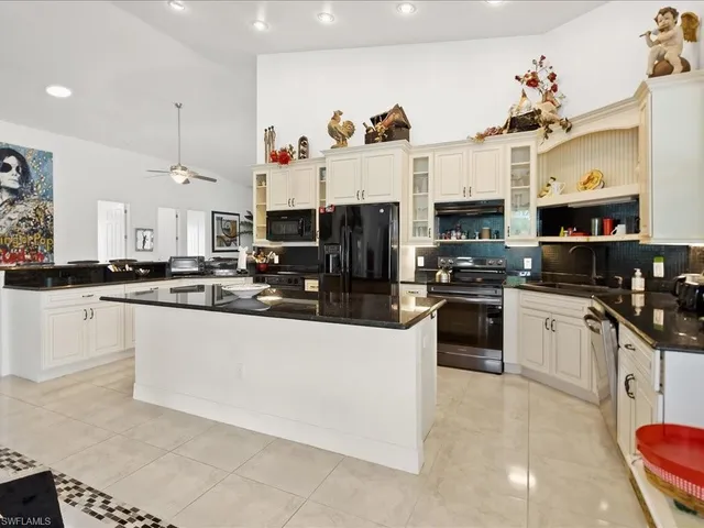 a kitchen with cabinets a sink and white appliances