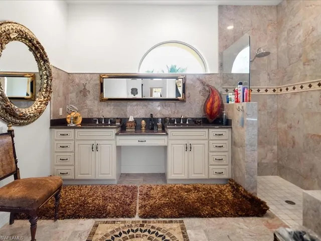 a kitchen with stainless steel appliances kitchen island a stove a sink and a white cabinets