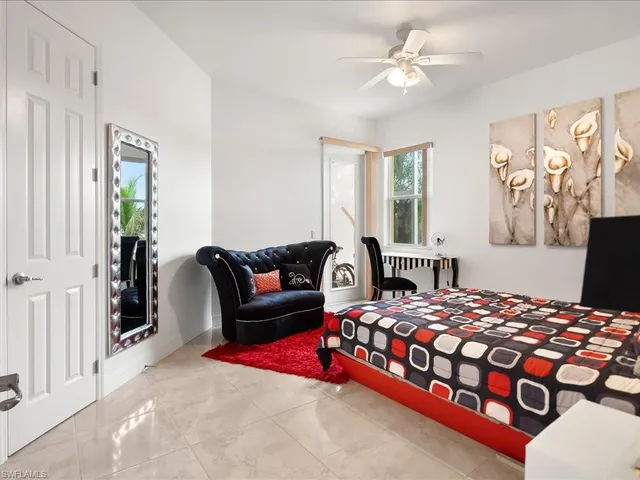 a bedroom with a bed couch and a window